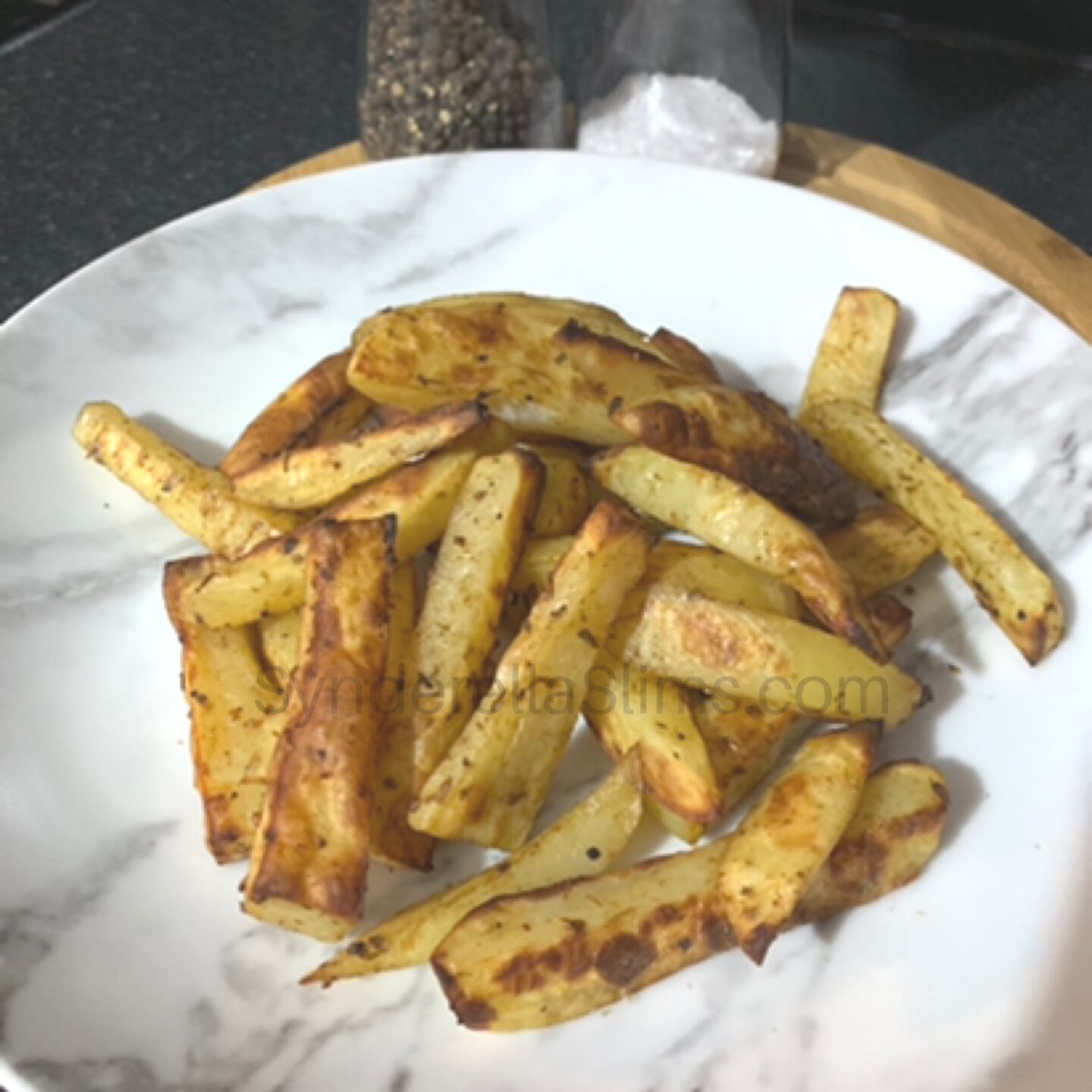 cooked hand made low syn chips in a pile on a plate looking tasty
